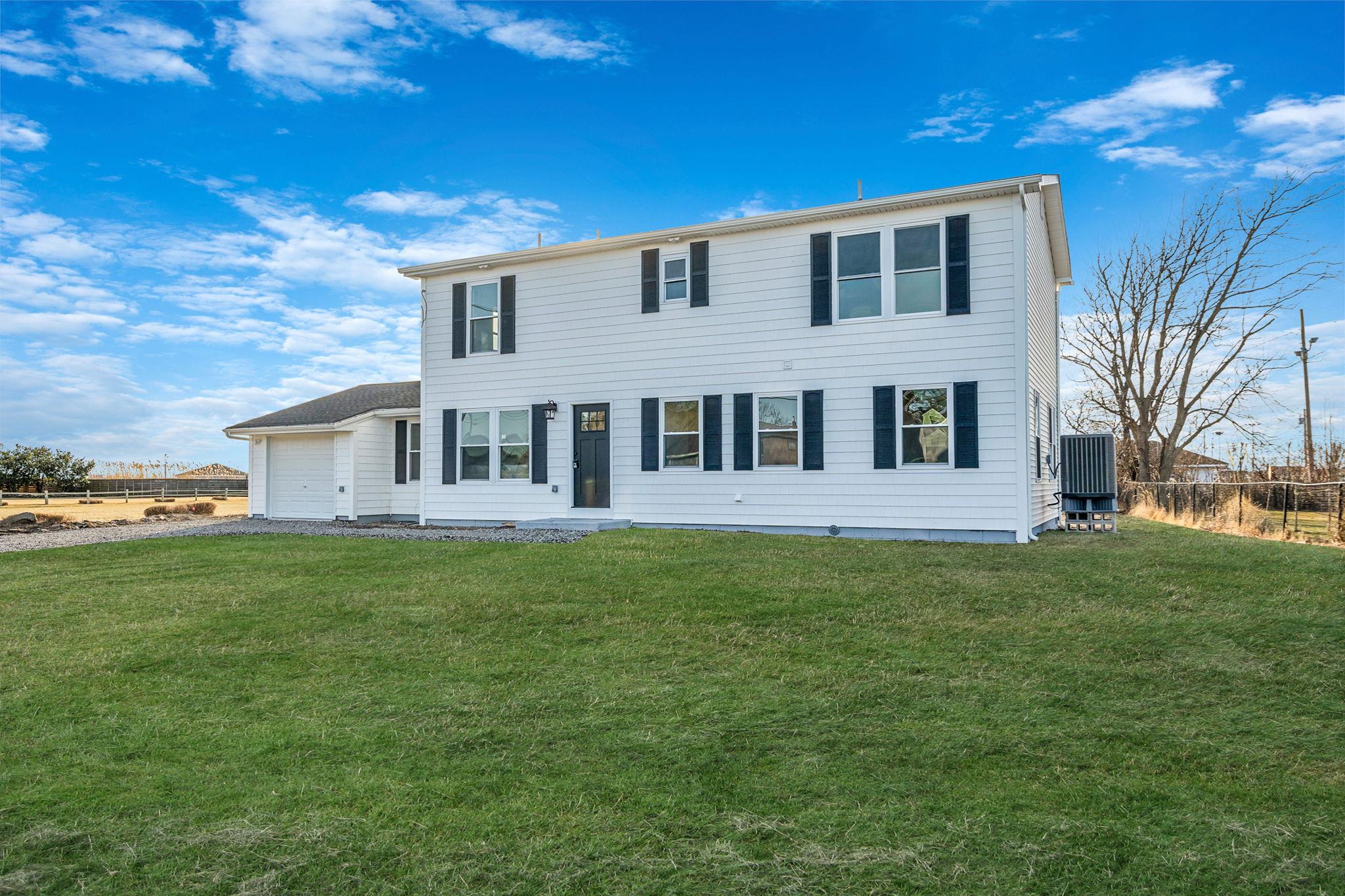 472 Bay Avenue Patchogue, NY 11772 - Photo 1 of 1 View of front of home with a garage and a front lawn