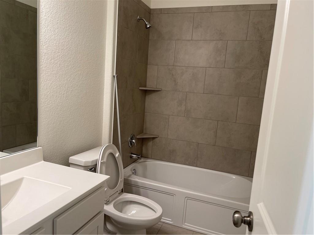 208 Baralo Street Leander, TX 78641 - Photo 17 of 23 a bathroom with a sink a toilet and shower