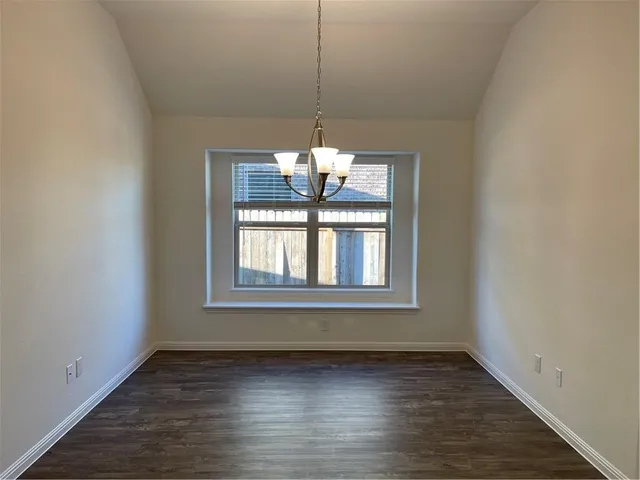 a view of a room window and wooden floor