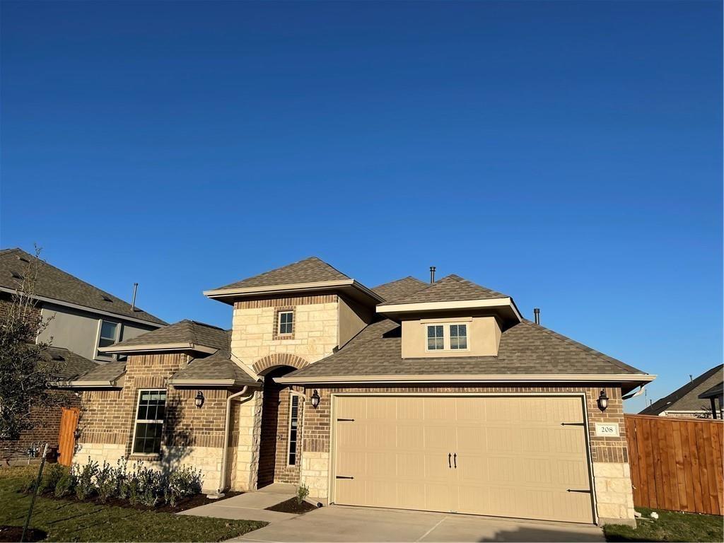 208 Baralo Street Leander, TX 78641 - Photo 2 of 23 a front view of a house with a yard
