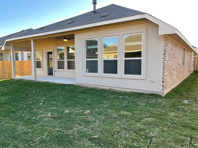a view of a house with a backyard