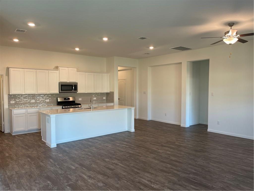 208 Baralo Street Leander, TX 78641 - Photo 5 of 23 a view of kitchen with granite countertop cabinets and refrigerator