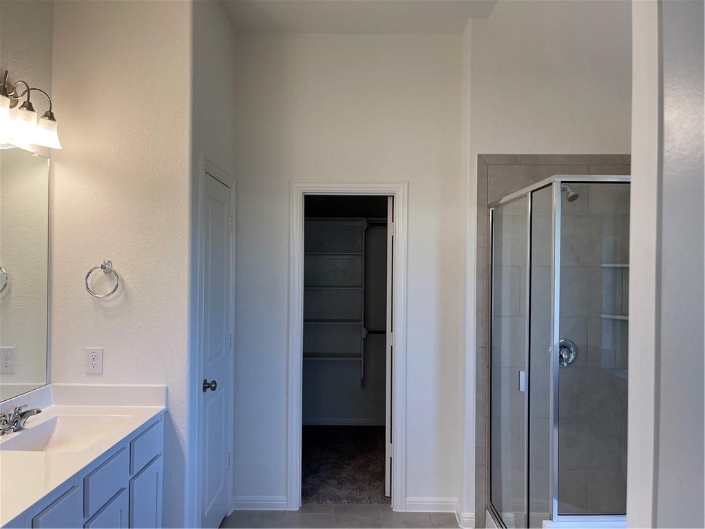 208 Baralo Street Leander, TX 78641 - Photo 10 of 23 a bathroom with a double vanity sink and a mirror