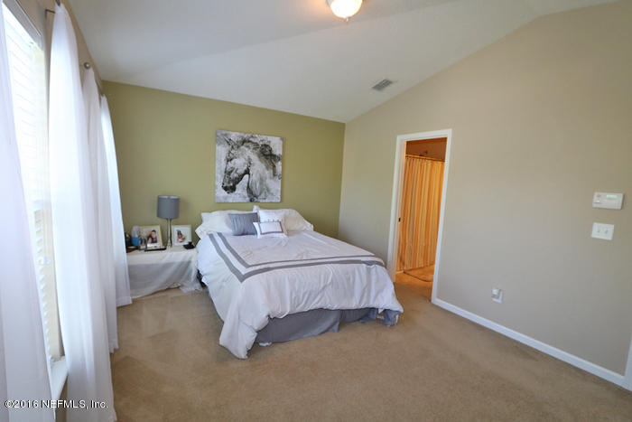 12935 Spring Rain Road Jacksonville, FL 32258 - Photo 12 of 28 a bedroom with a bed and a window