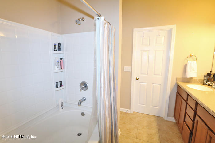 12935 Spring Rain Road Jacksonville, FL 32258 - Photo 13 of 28 a bathroom with a shower and a sink
