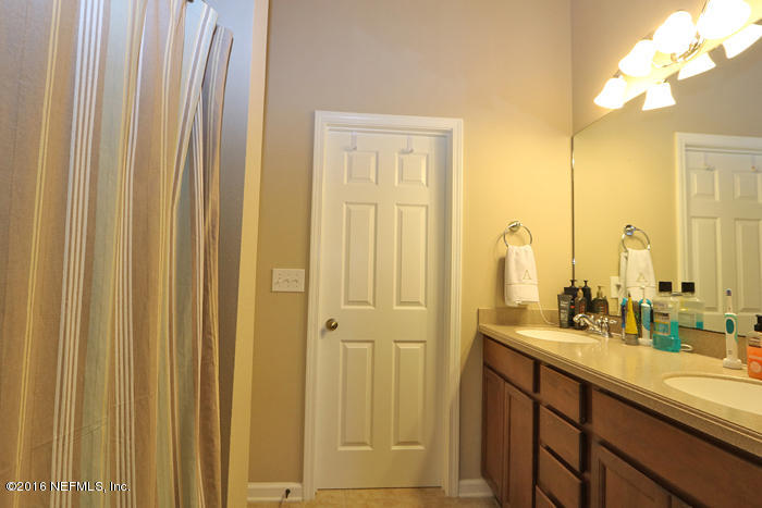 12935 Spring Rain Road Jacksonville, FL 32258 - Photo 14 of 28 a bathroom with a double vanity sink and a mirror