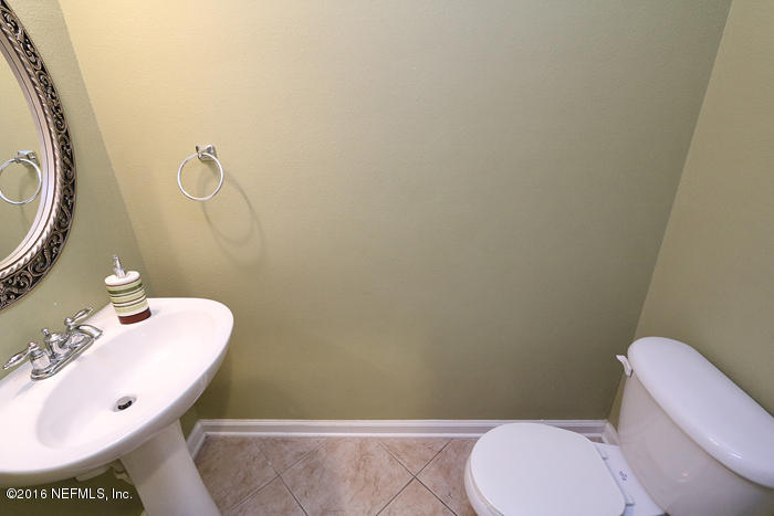 12935 Spring Rain Road Jacksonville, FL 32258 - Photo 18 of 28 a bathroom with a toilet and a sink