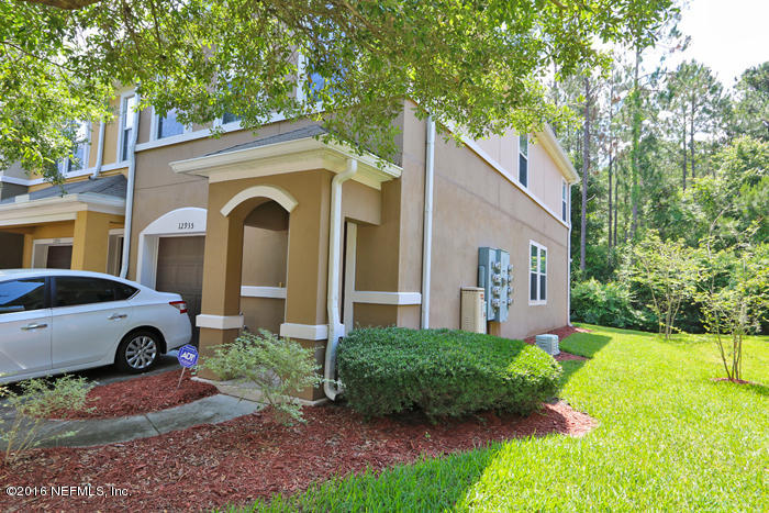 12935 Spring Rain Road Jacksonville, FL 32258 - Photo 2 of 28 a front view of a house with a garden