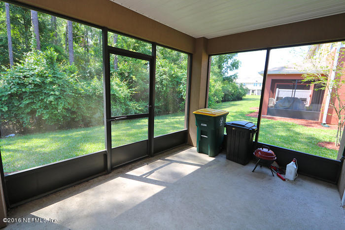 12935 Spring Rain Road Jacksonville, FL 32258 - Photo 22 of 28 a view of a porch with furniture and a yard