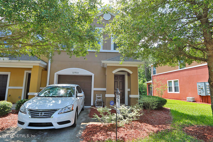 12935 Spring Rain Road Jacksonville, FL 32258 - Photo 23 of 28 a front view of a house with garden