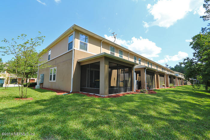 12935 Spring Rain Road Jacksonville, FL 32258 - Photo 25 of 28 a front view of house with a garden