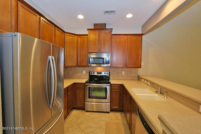 12935 Spring Rain Road Jacksonville, FL 32258 - Photo 3 of 28 a kitchen with a refrigerator sink and stove
