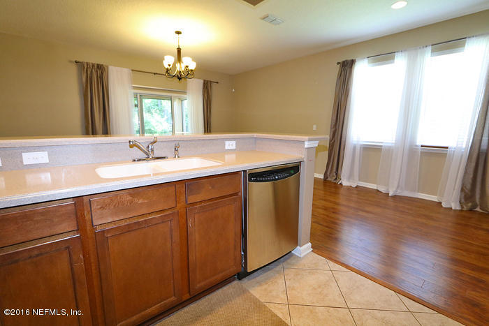 12935 Spring Rain Road Jacksonville, FL 32258 - Photo 5 of 28 a en suite bathroom with a sink mirror and a shower
