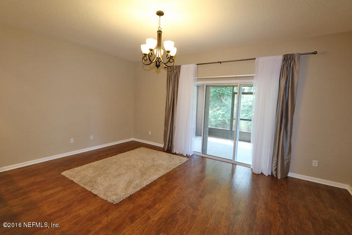 12935 Spring Rain Road Jacksonville, FL 32258 - Photo 7 of 28 a view of a room with wooden floor and large window