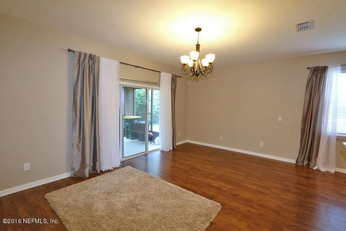 12935 Spring Rain Road Jacksonville, FL 32258 - Photo 8 of 28 wooden floor in an empty room with a window