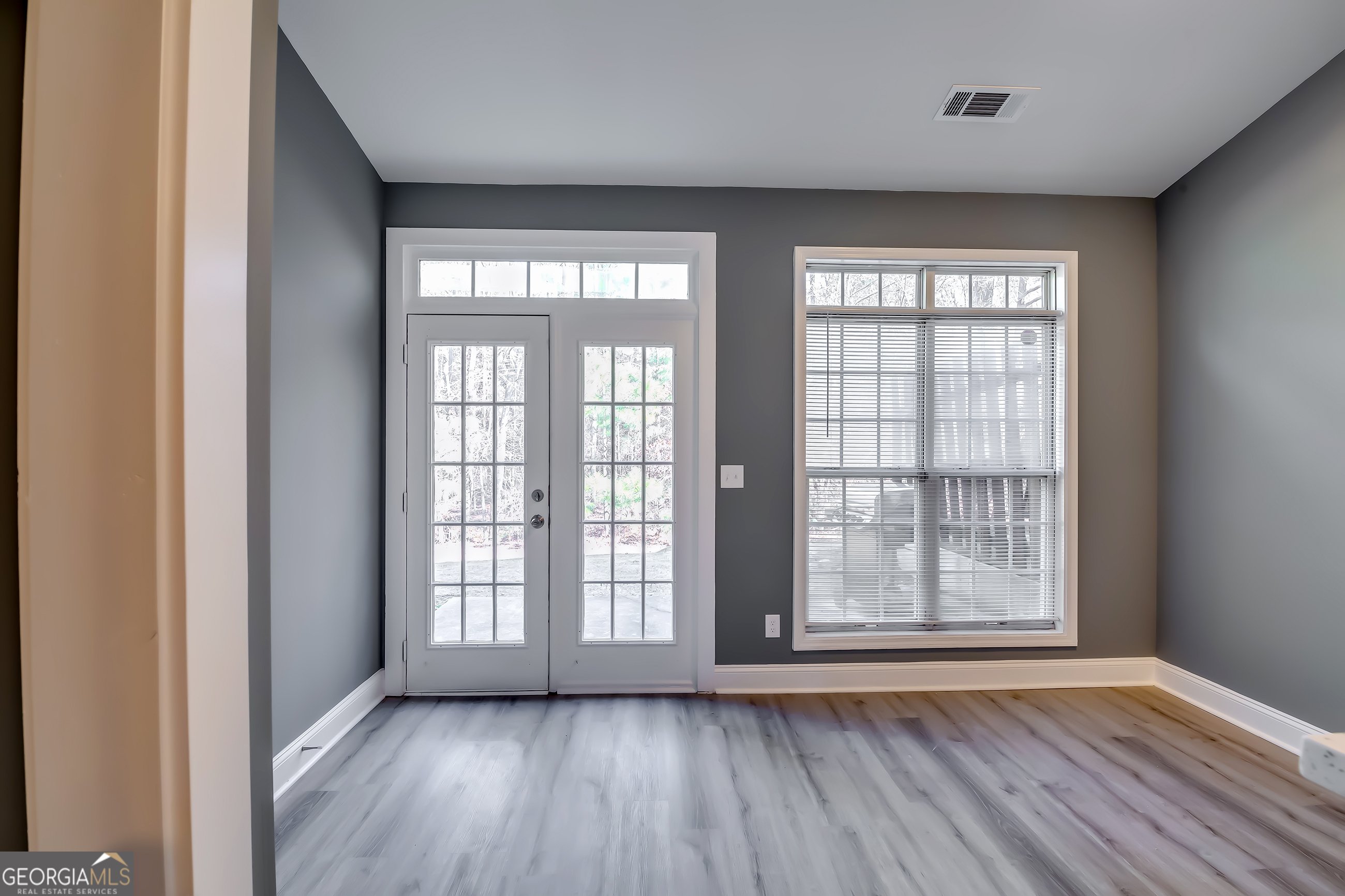 6269 Colonial View Fairburn, GA 30213 - Photo 2 of 13 a view of an empty room with wooden floor and a window