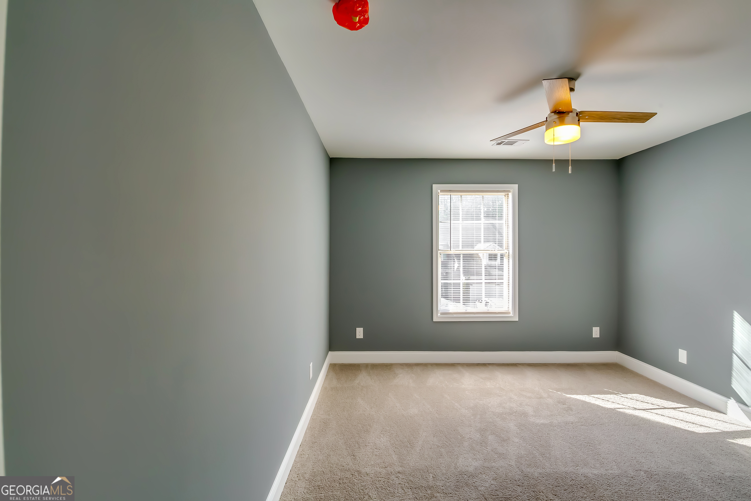 6269 Colonial View Fairburn, GA 30213 - Photo 6 of 13 an empty room with a window and a ceiling fan
