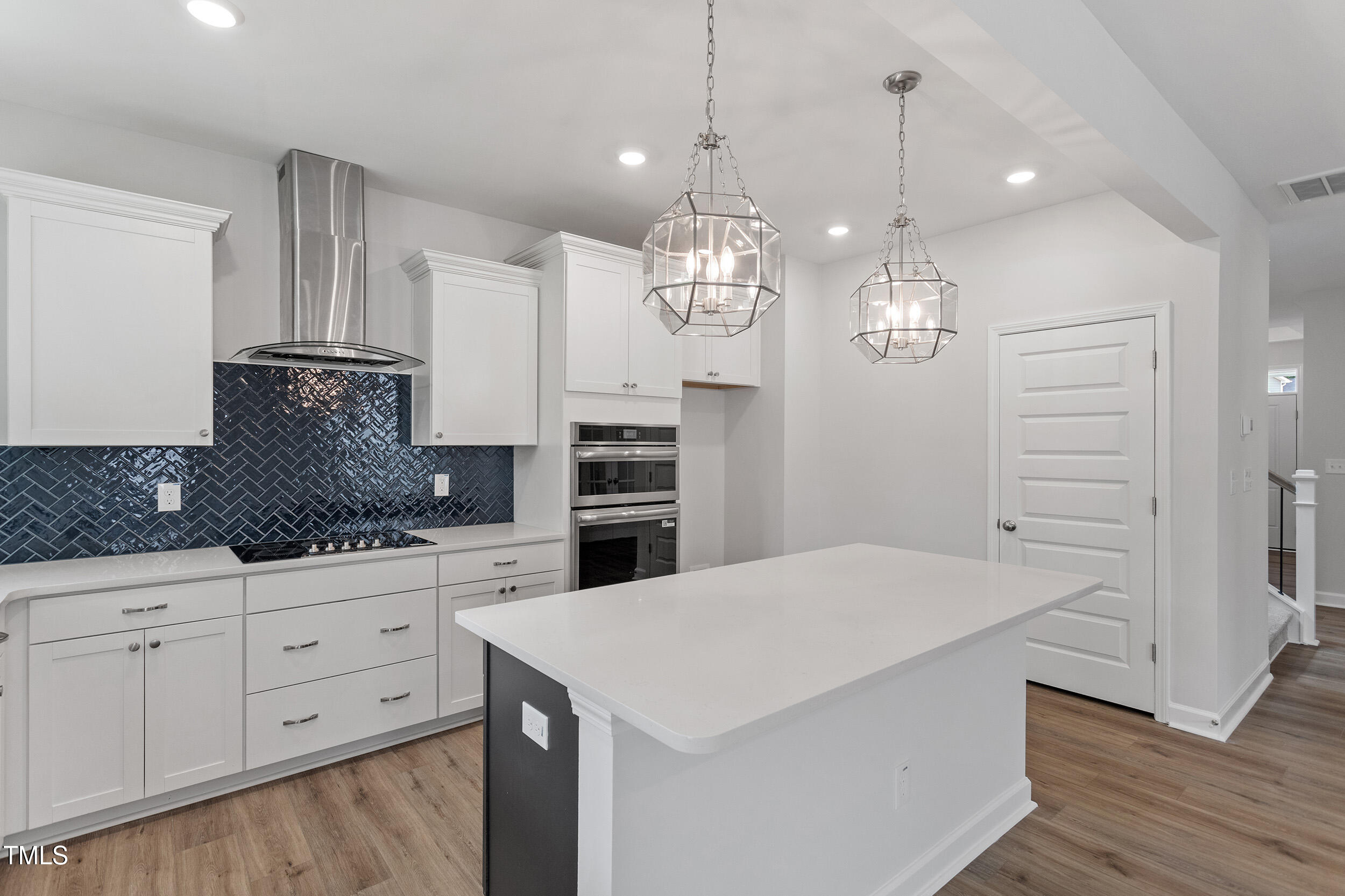 239 Meadowbark Bend, Unit 27 Garner, NC 27529 - Photo 11 of 36 a kitchen that has a lot of cabinets and wooden floor