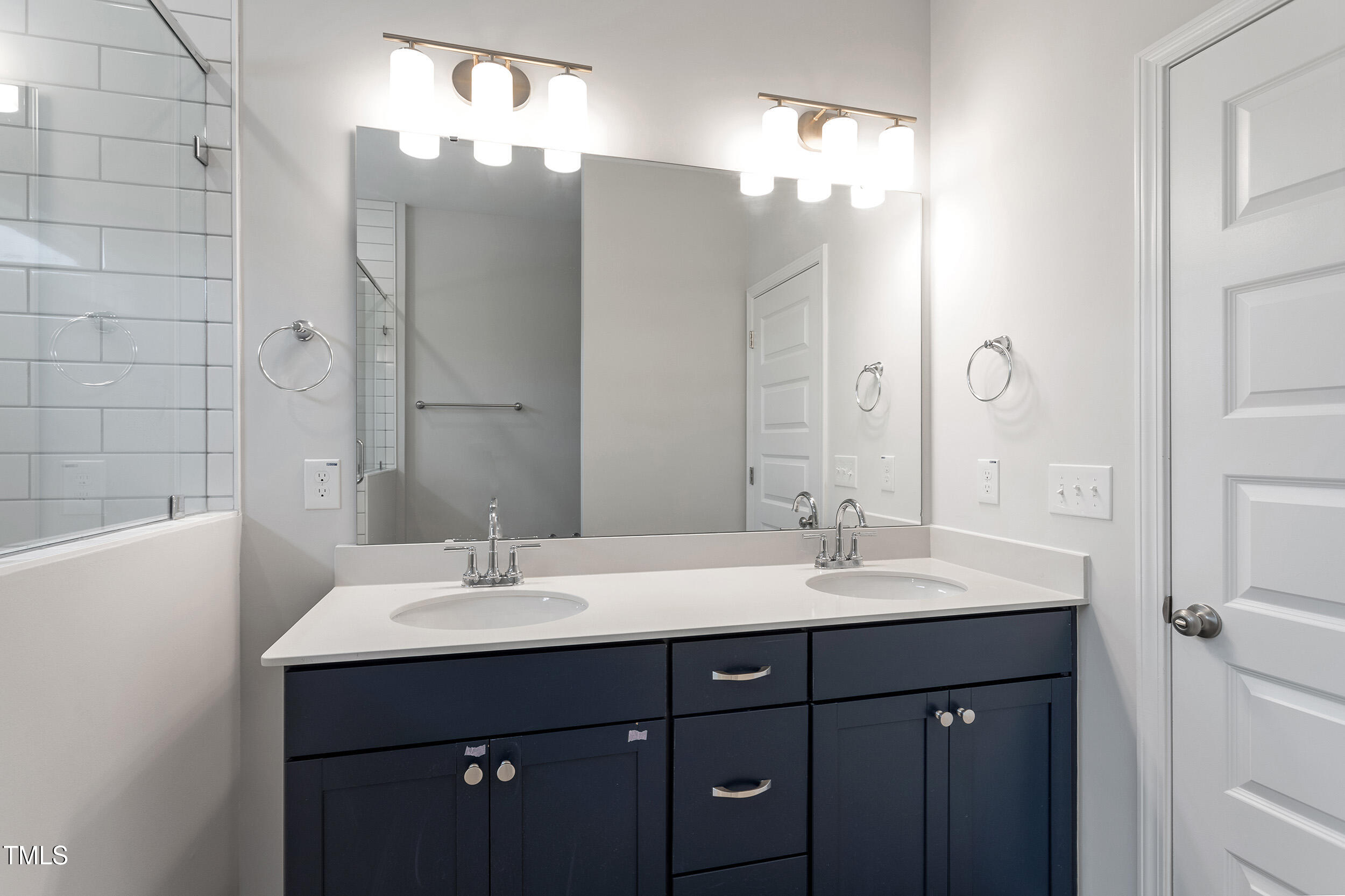 239 Meadowbark Bend, Unit 27 Garner, NC 27529 - Photo 18 of 36 a bathroom with a sink double vanity and a mirror