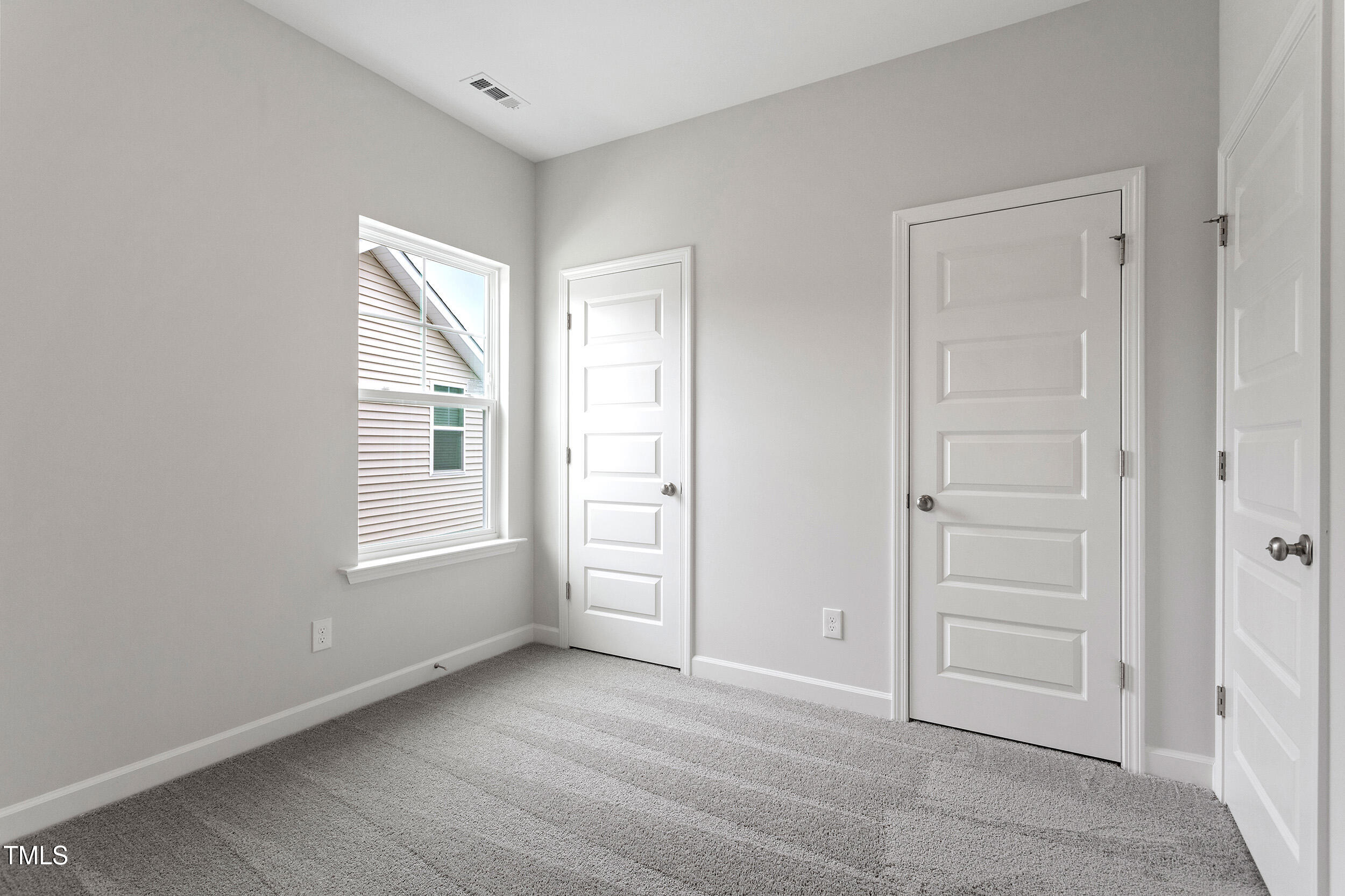 239 Meadowbark Bend, Unit 27 Garner, NC 27529 - Photo 23 of 36 a view of an empty room with a window
