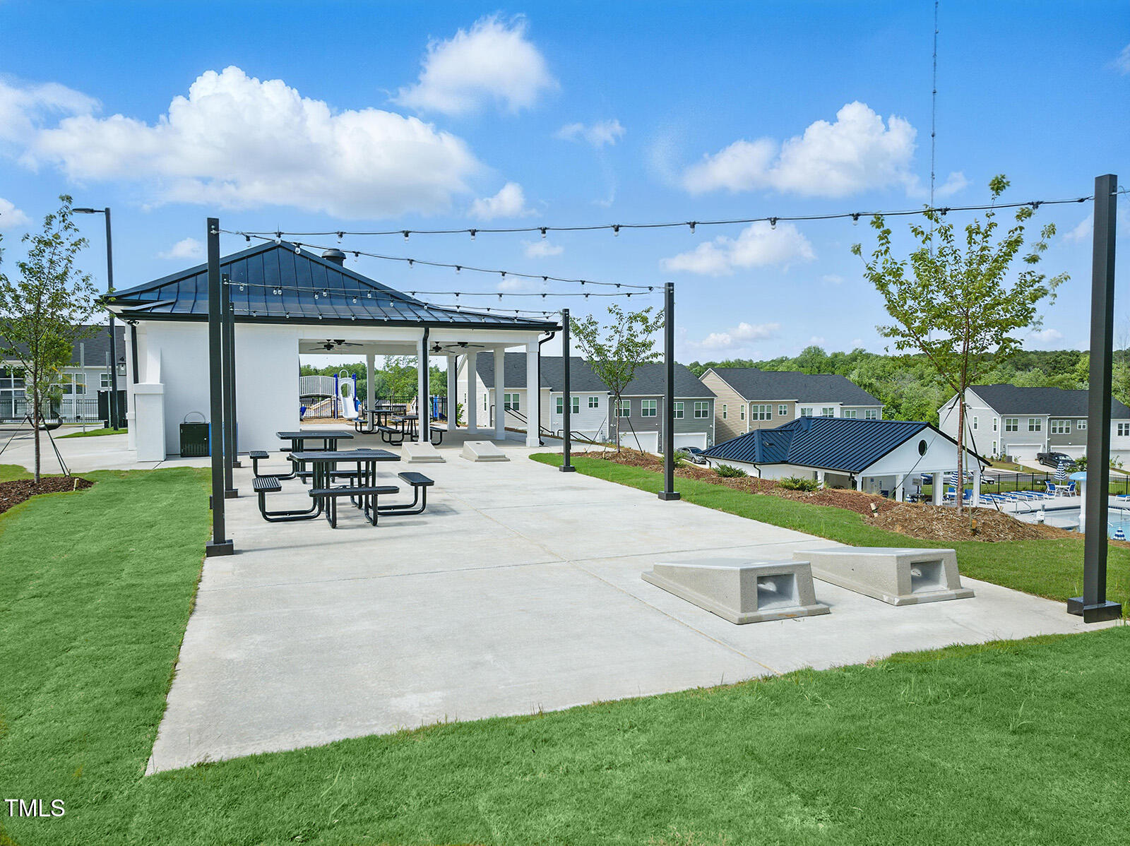 239 Meadowbark Bend, Unit 27 Garner, NC 27529 - Photo 29 of 36 a white house with a big yard and potted plants