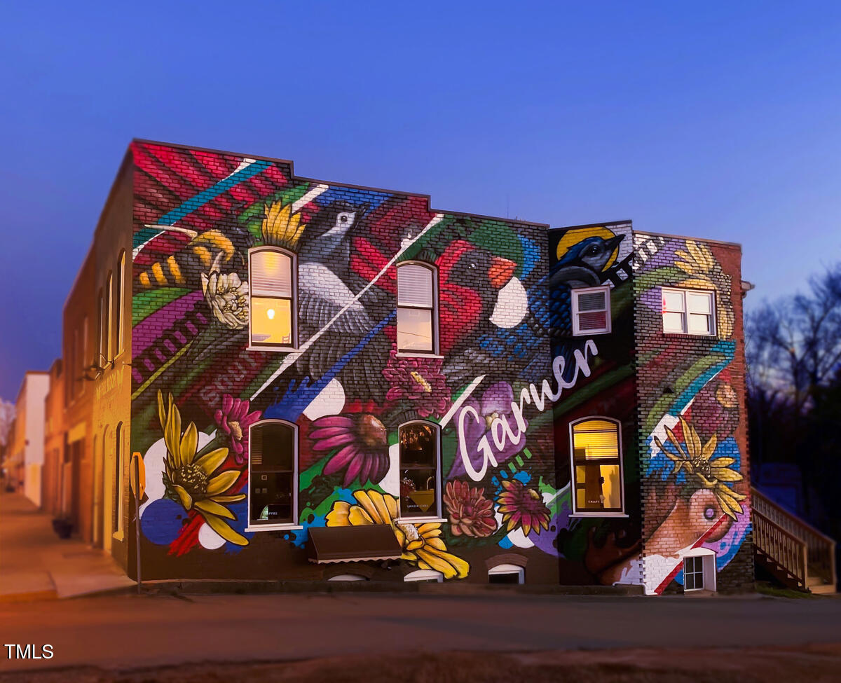 239 Meadowbark Bend, Unit 27 Garner, NC 27529 - Photo 32 of 36 a view of a street with many windows