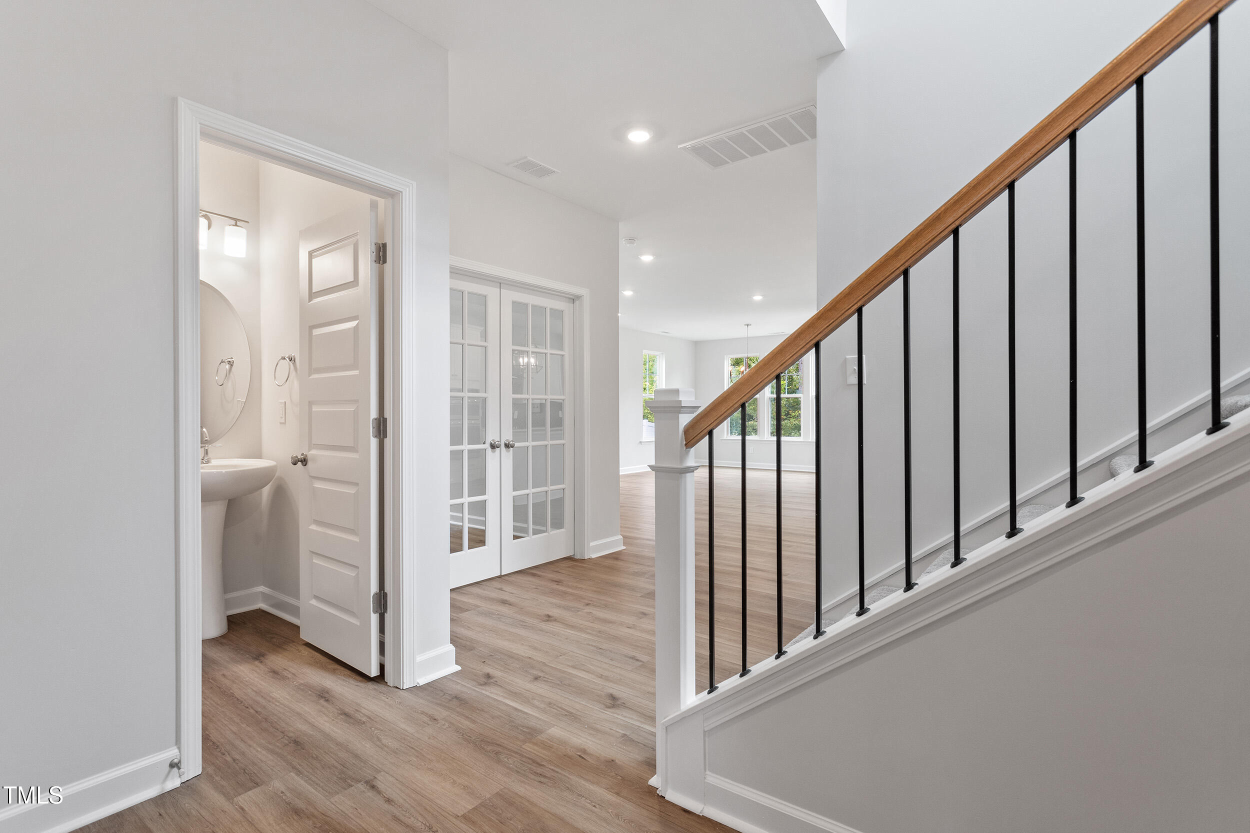 239 Meadowbark Bend, Unit 27 Garner, NC 27529 - Photo 3 of 36 a view of a hallway with wooden floor and staircase