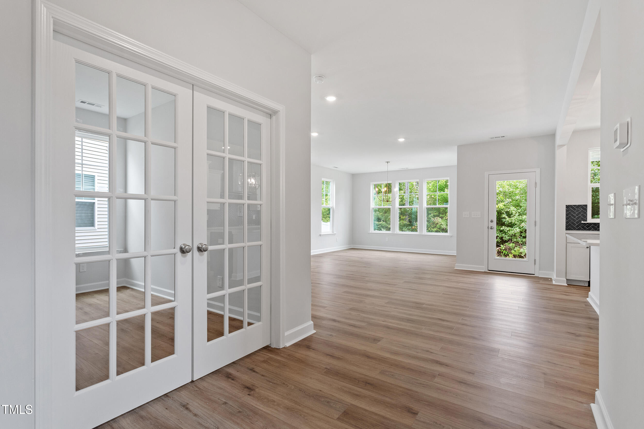 239 Meadowbark Bend, Unit 27 Garner, NC 27529 - Photo 4 of 36 a view of an empty room with wooden floor and a window