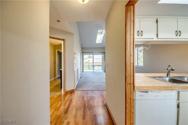 a view of a hallway with wooden floor and closet