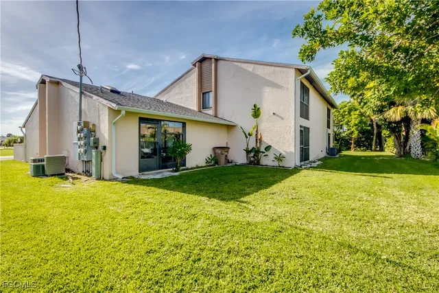 a front view of house with yard and green space