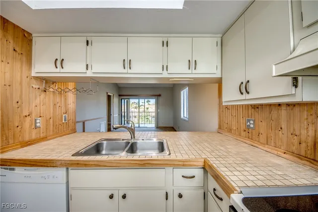 a kitchen with granite countertop a sink and cabinets