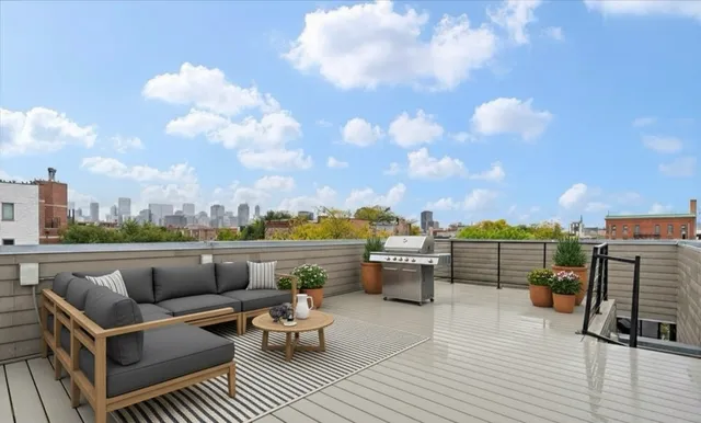 a view of city from terrace with seating