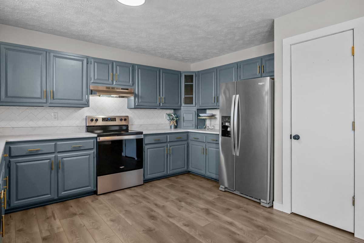 365 Little Benton Road Mansfield, TN 38236 - Photo 18 of 53 a kitchen with a refrigerator sink and wooden cabinets