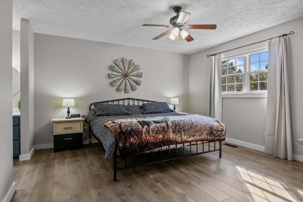 365 Little Benton Road Mansfield, TN 38236 - Photo 20 of 53 a bedroom with a bed and a chandelier