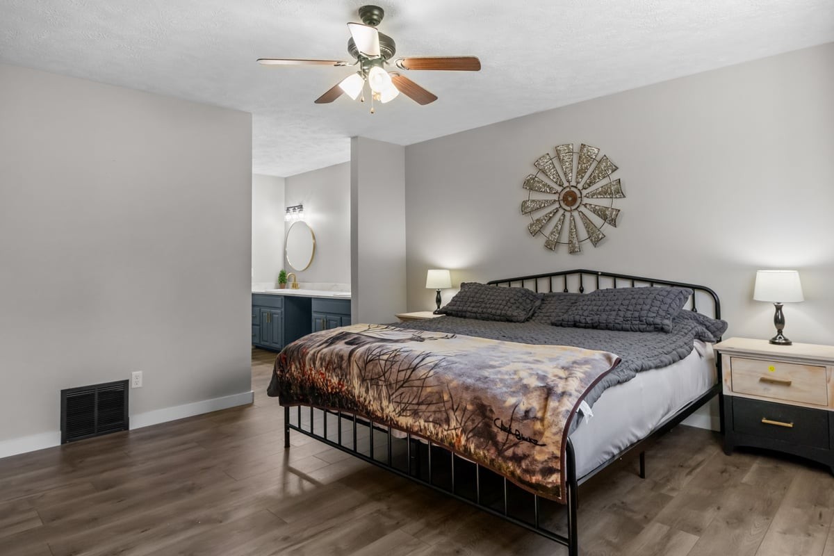 365 Little Benton Road Mansfield, TN 38236 - Photo 22 of 53 a bedroom with a bed and a chandelier