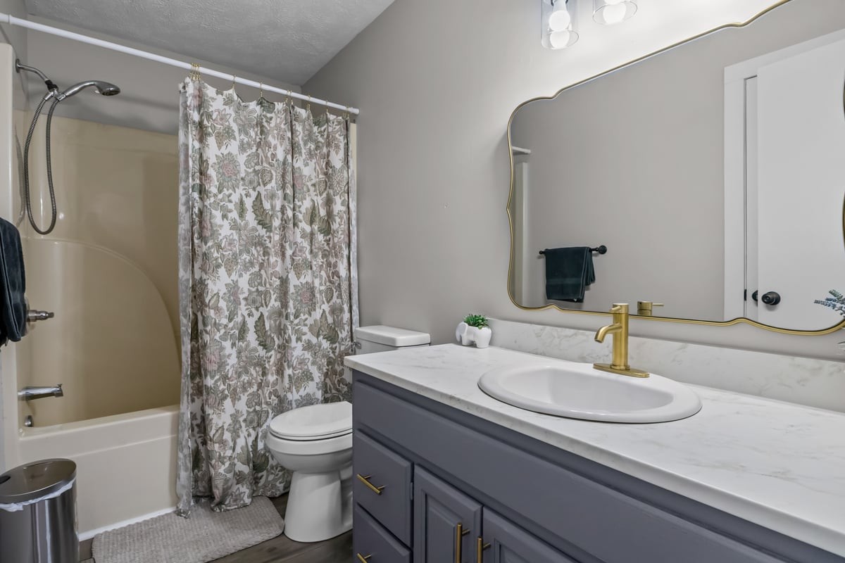 365 Little Benton Road Mansfield, TN 38236 - Photo 25 of 53 a bathroom with a granite countertop sink toilet a mirror and shower