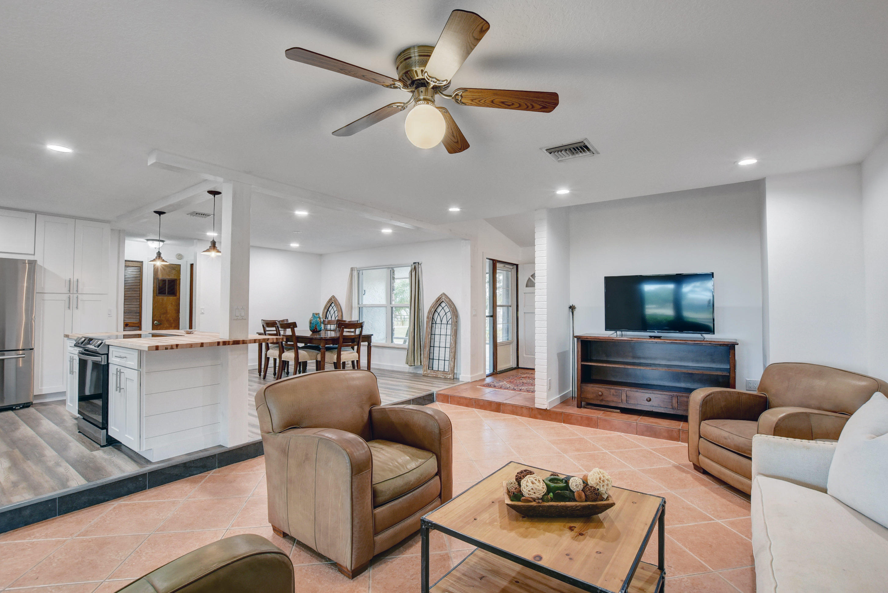 16493 Rustic Road Wellington, FL 33470 - Photo 12 of 57 a living room with furniture and a flat screen tv