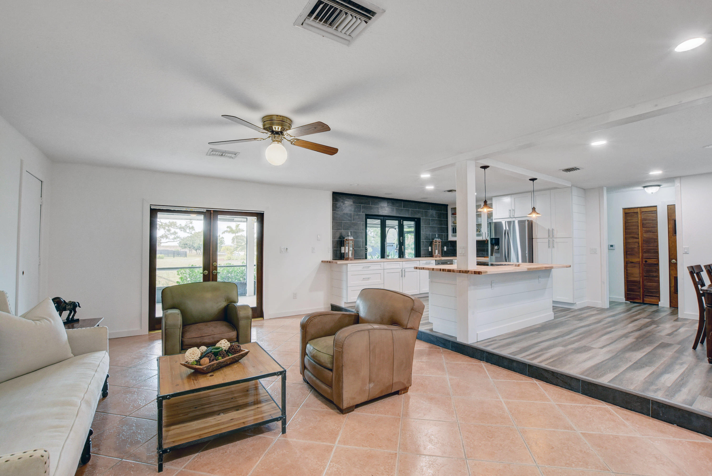 16493 Rustic Road Wellington, FL 33470 - Photo 13 of 57 a living room with furniture and a table