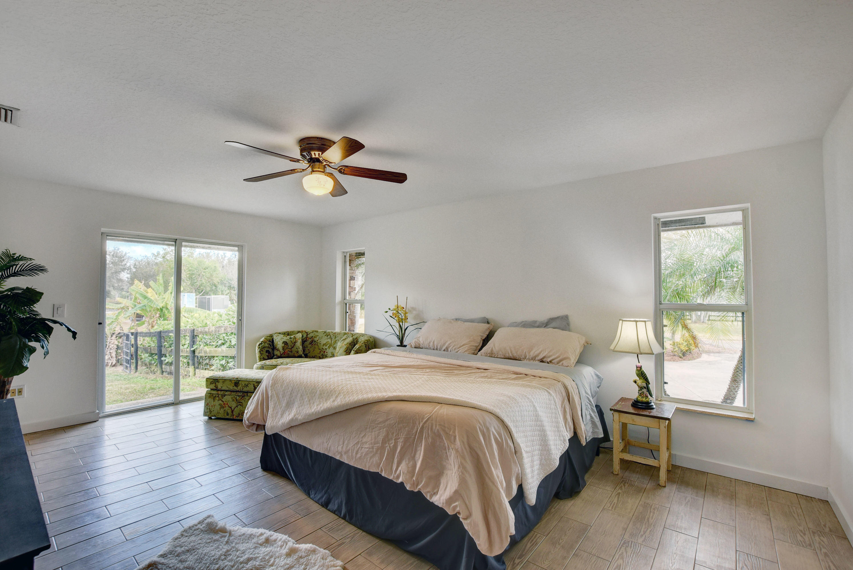 16493 Rustic Road Wellington, FL 33470 - Photo 14 of 57 a spacious bedroom with a bed and a large window