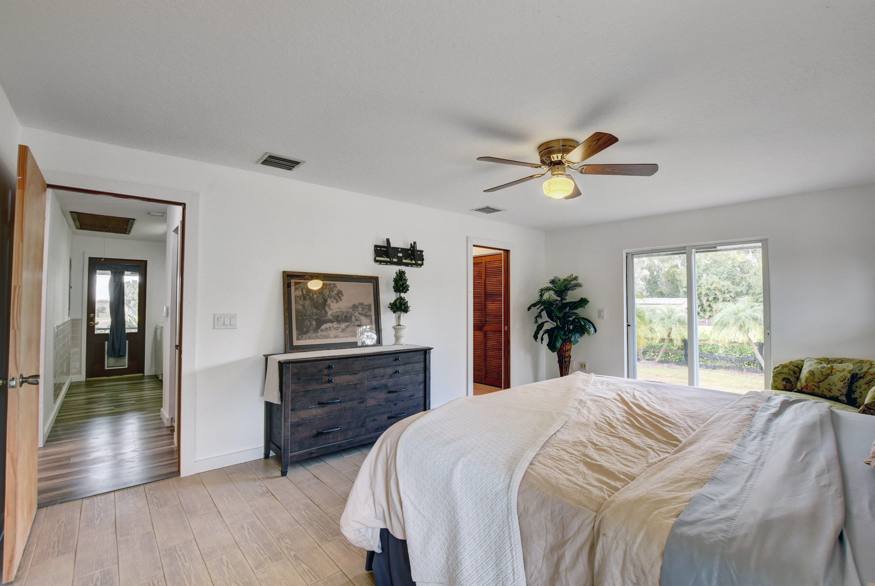 16493 Rustic Road Wellington, FL 33470 - Photo 15 of 57 a bedroom with a bed and a dresser