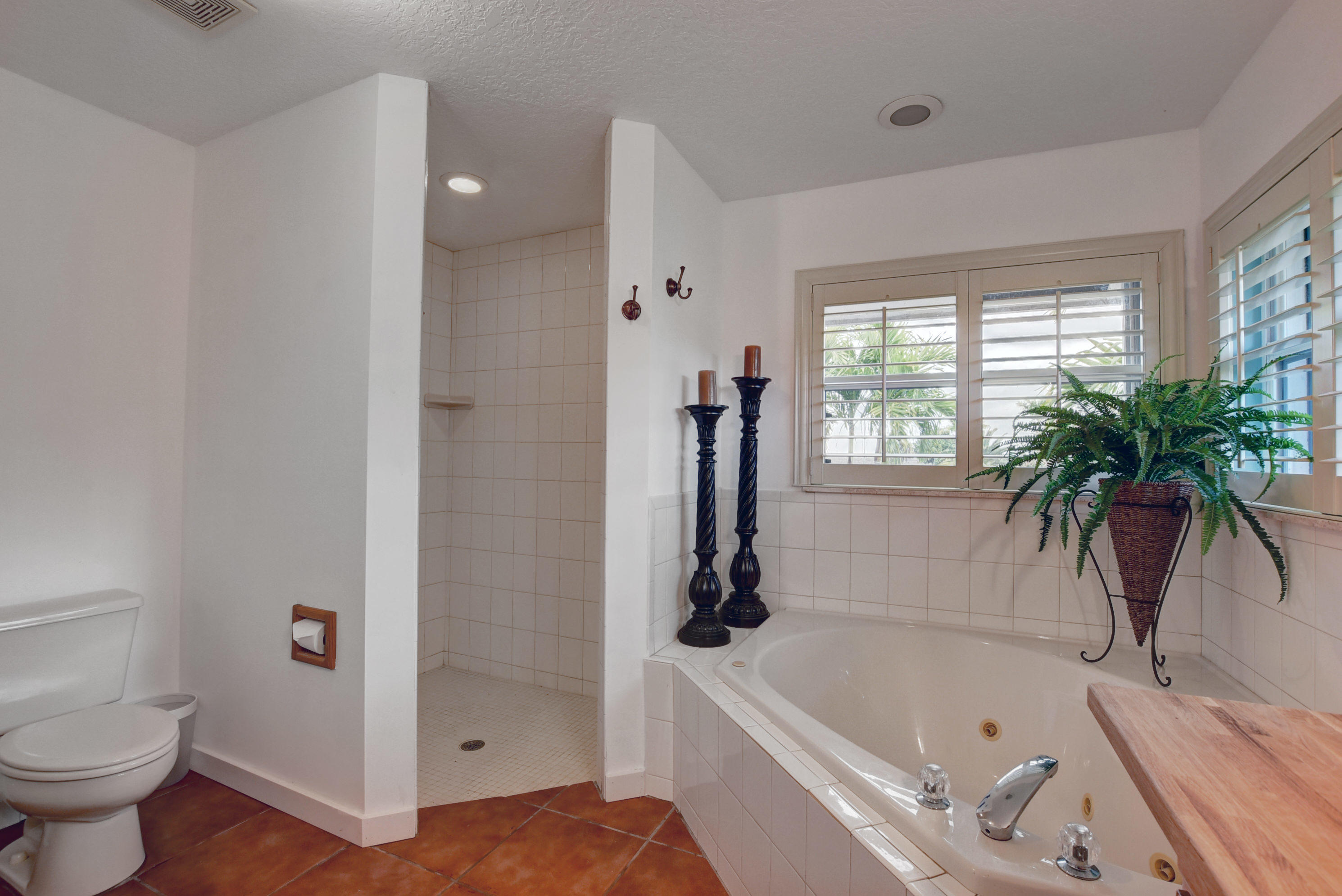 16493 Rustic Road Wellington, FL 33470 - Photo 17 of 57 a bathroom with a tub a sink and a shower