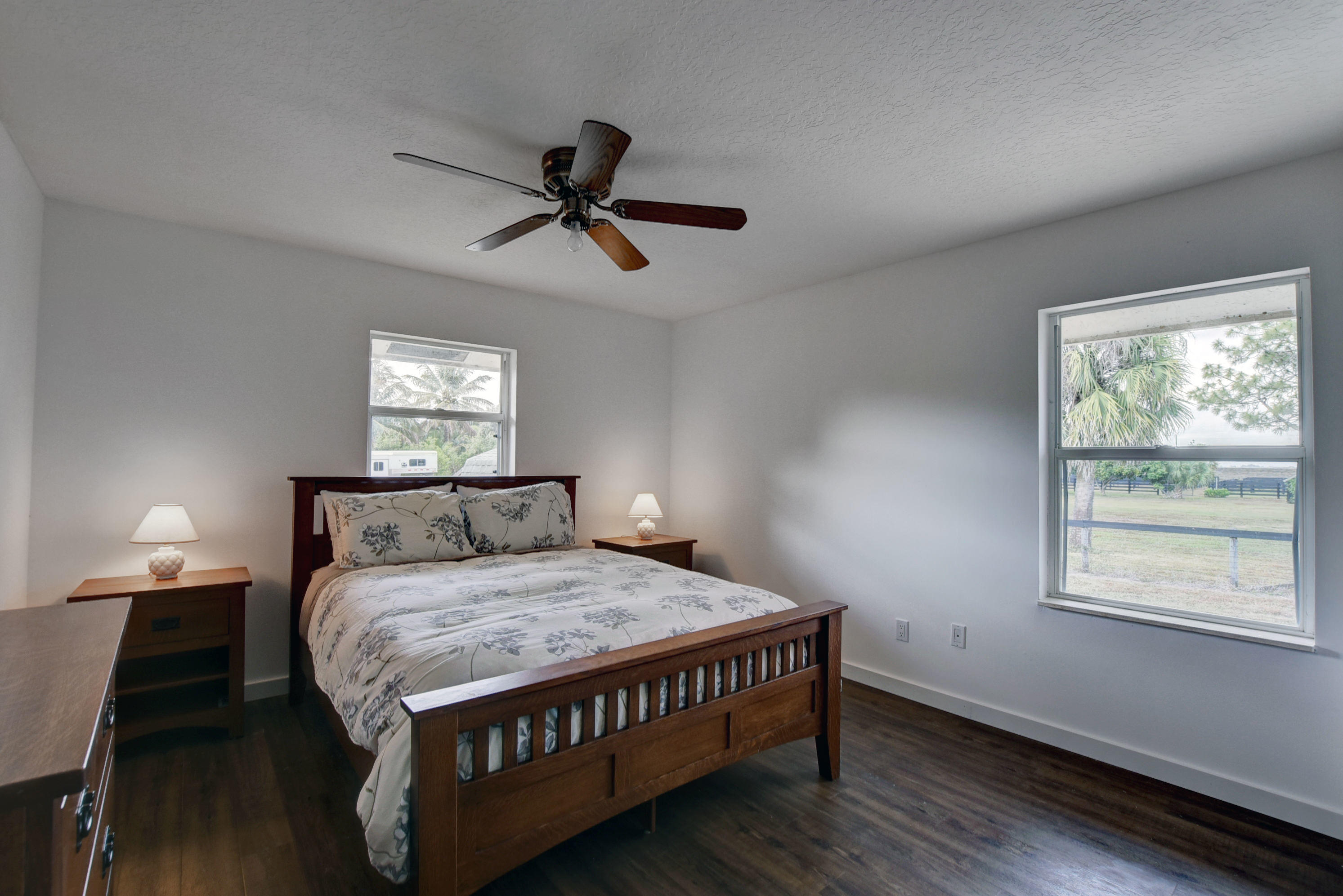 16493 Rustic Road Wellington, FL 33470 - Photo 19 of 57 a bed sitting in a bedroom next to a window