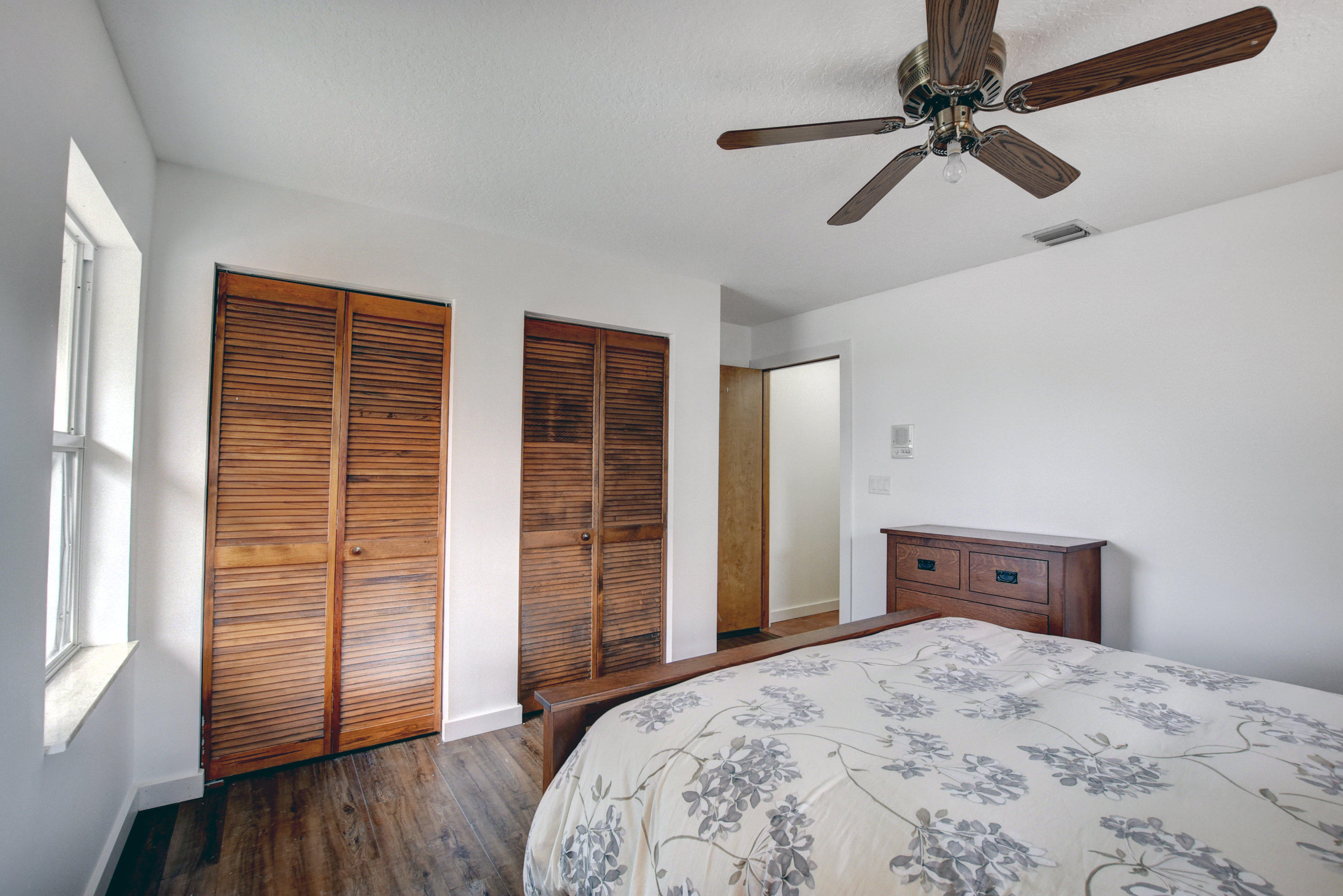 16493 Rustic Road Wellington, FL 33470 - Photo 20 of 57 a bedroom with a bed and wooden floor