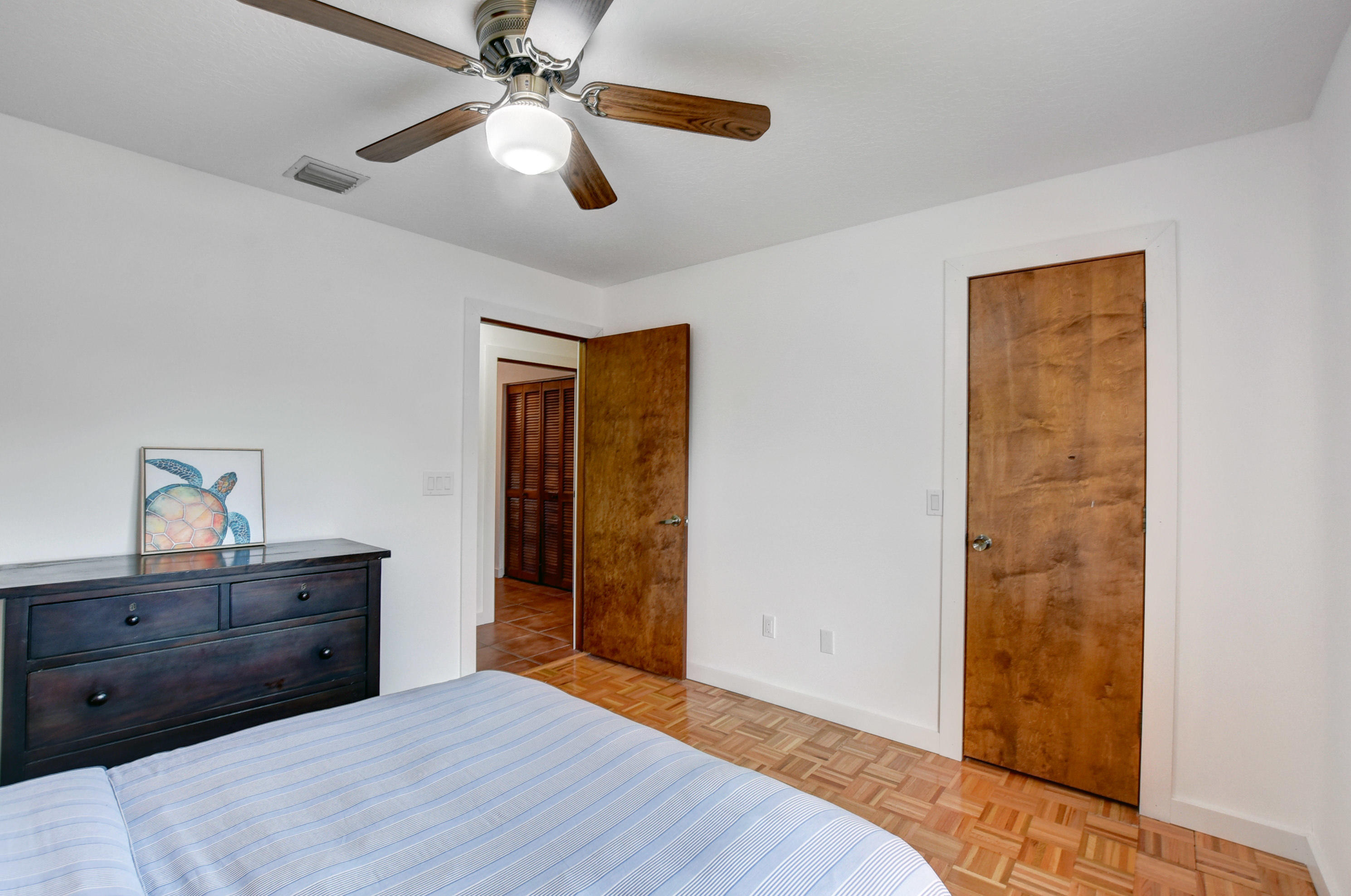 16493 Rustic Road Wellington, FL 33470 - Photo 22 of 57 a room that has a bed and a dresser