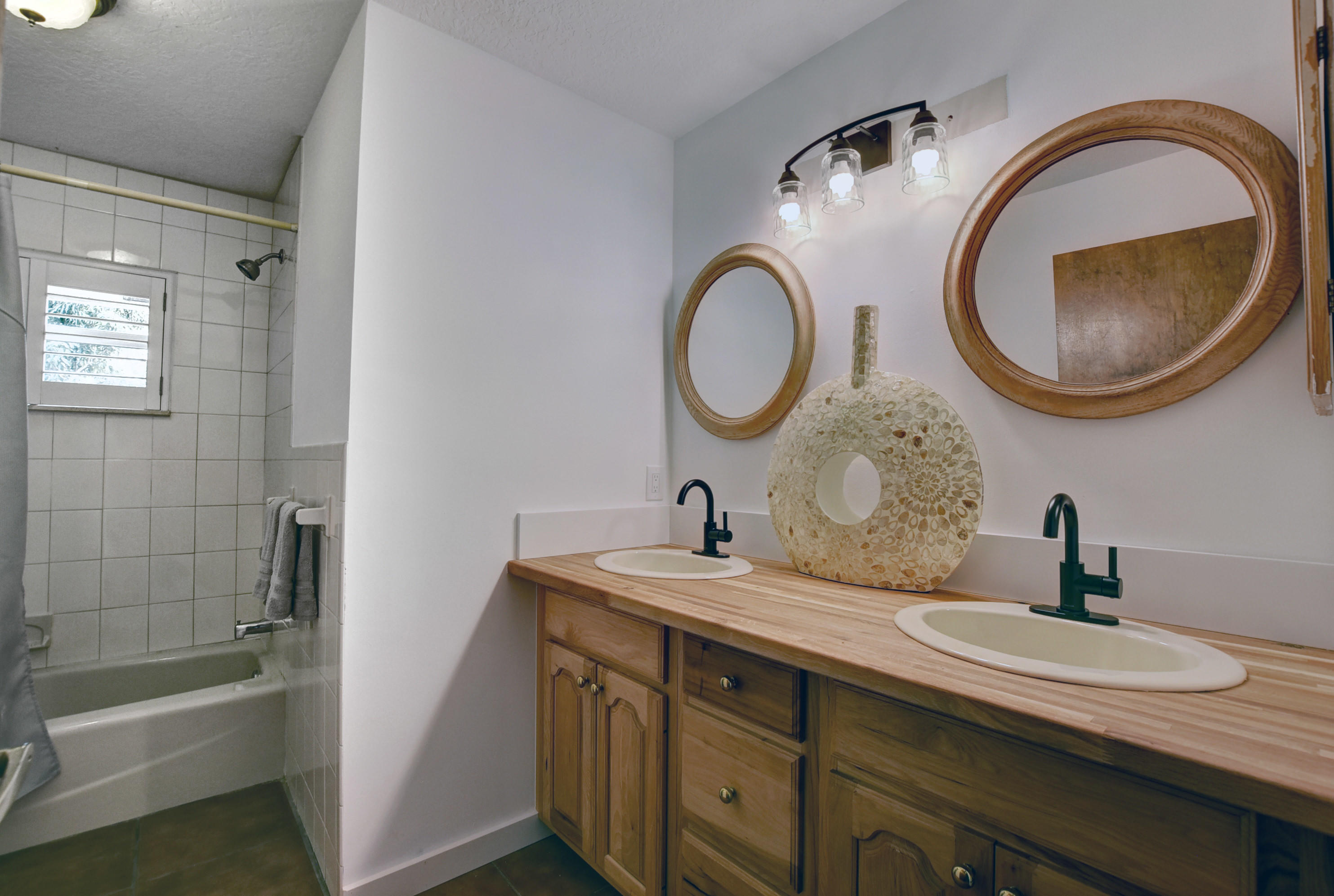 16493 Rustic Road Wellington, FL 33470 - Photo 23 of 57 a bathroom with a granite countertop toilet a sink and a mirror