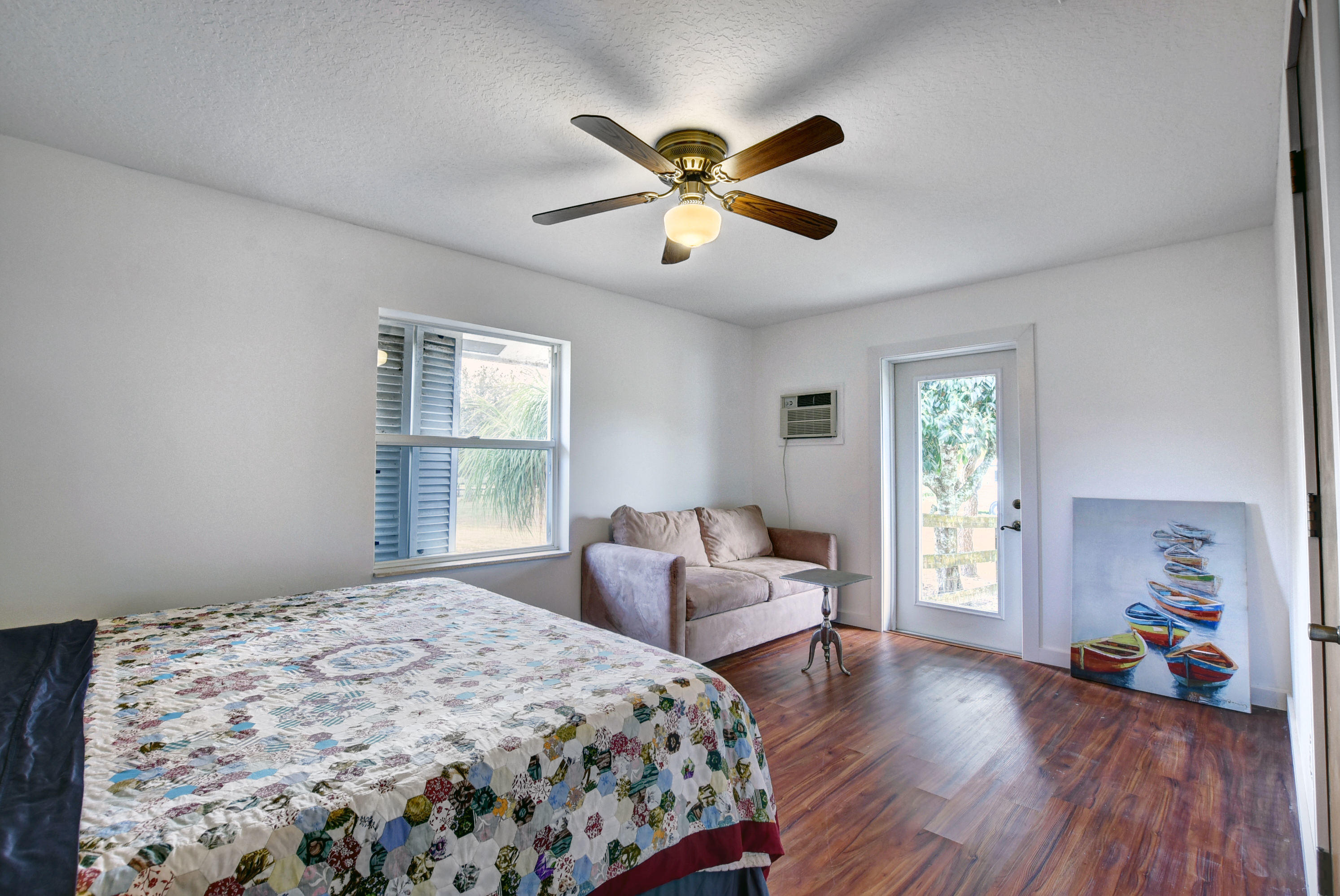 16493 Rustic Road Wellington, FL 33470 - Photo 24 of 57 a bedroom with bed and windows