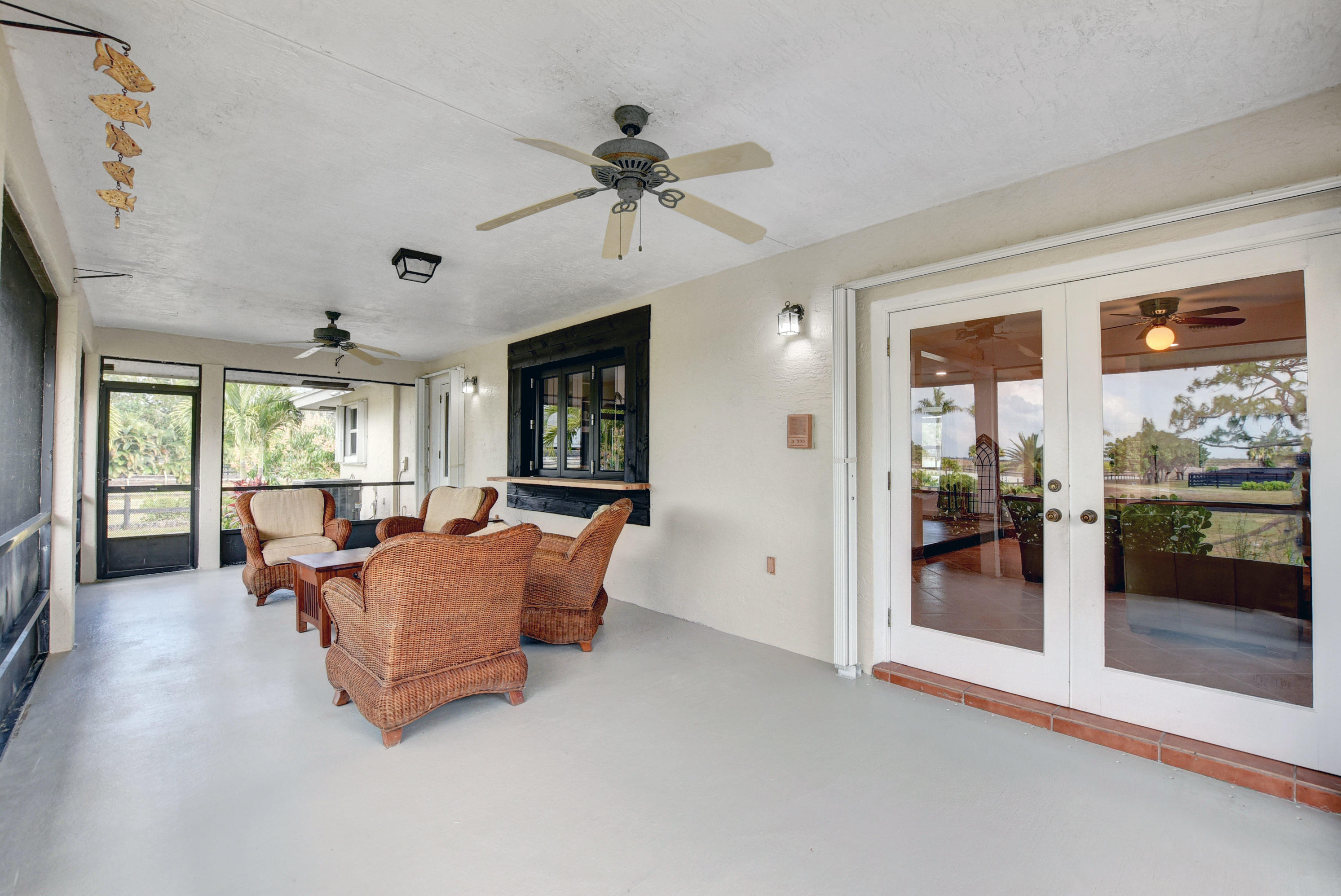 16493 Rustic Road Wellington, FL 33470 - Photo 25 of 57 a living room with furniture and a large window