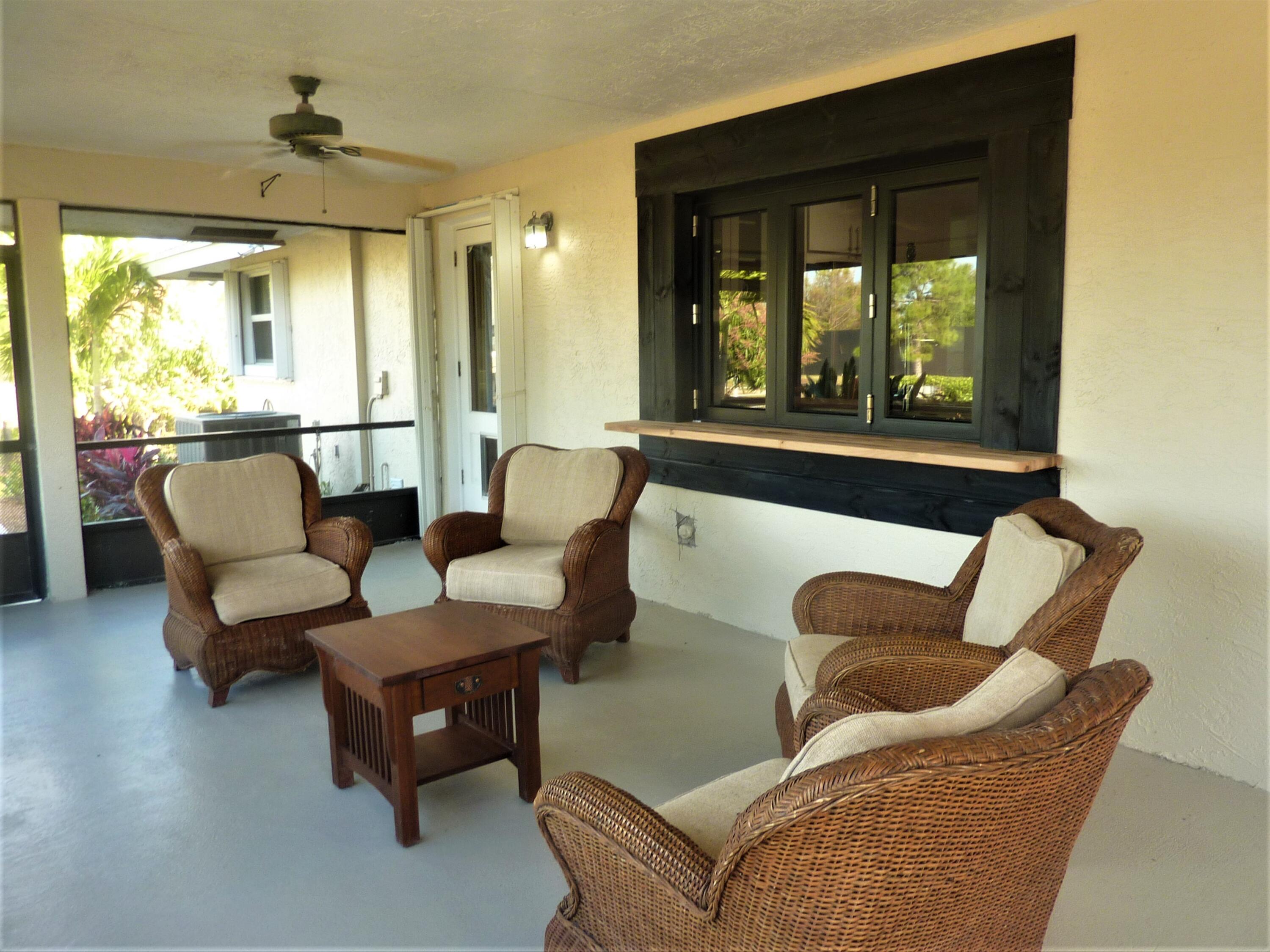 16493 Rustic Road Wellington, FL 33470 - Photo 27 of 57 a living room with furniture and a large window