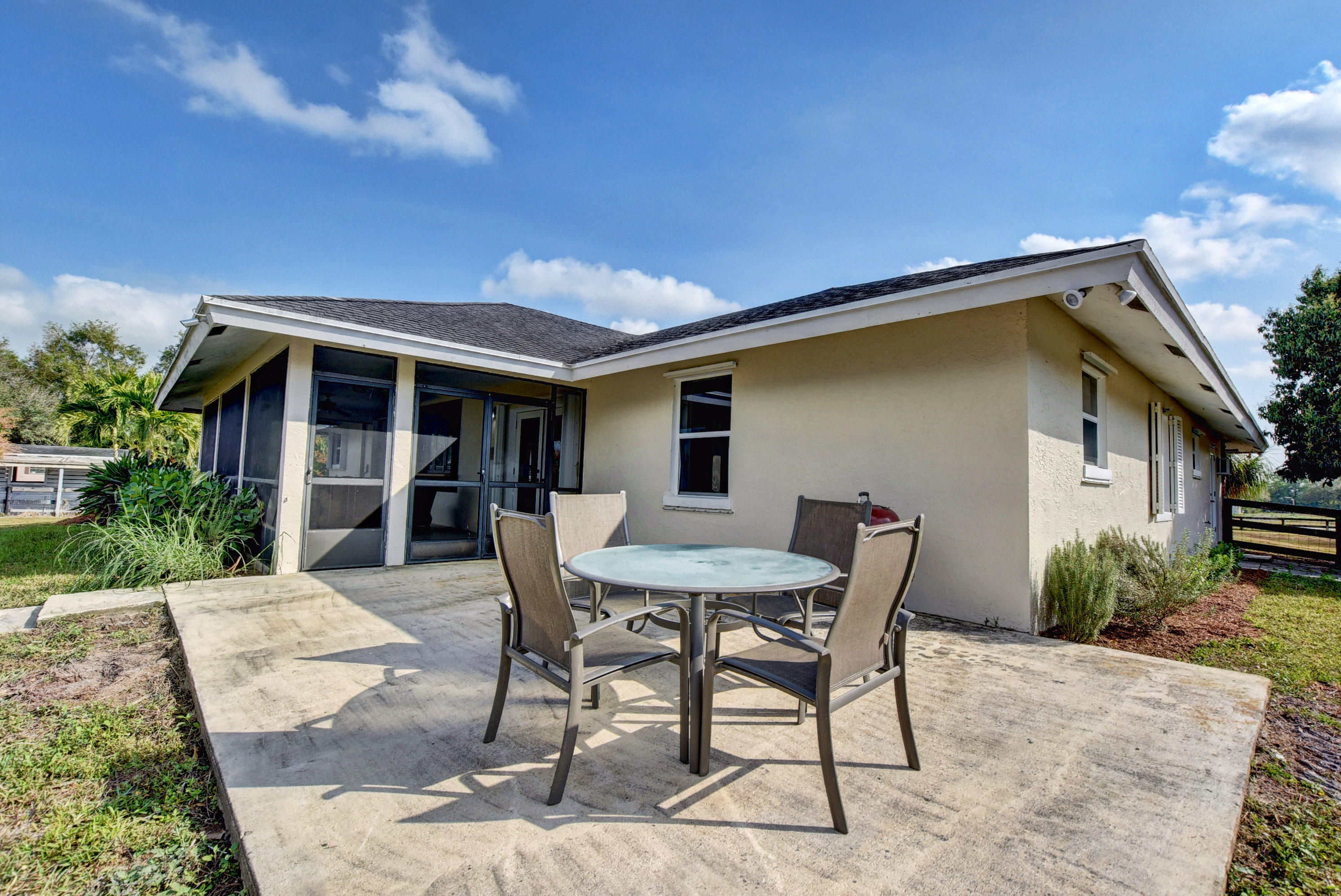 16493 Rustic Road Wellington, FL 33470 - Photo 28 of 57 a view of a house with backyard and sitting area