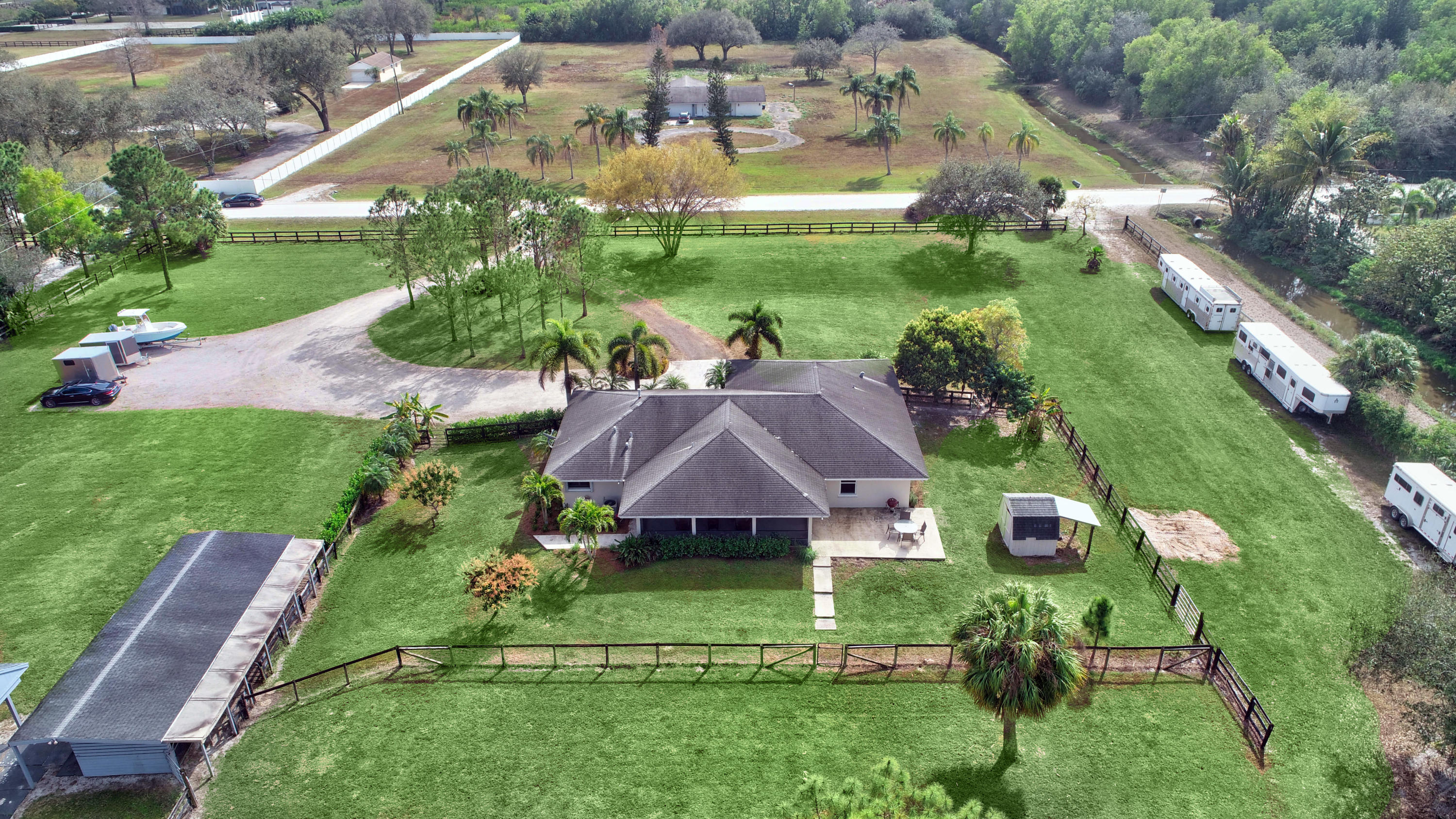 16493 Rustic Road Wellington, FL 33470 - Photo 35 of 57 a view of house with garden space and street view